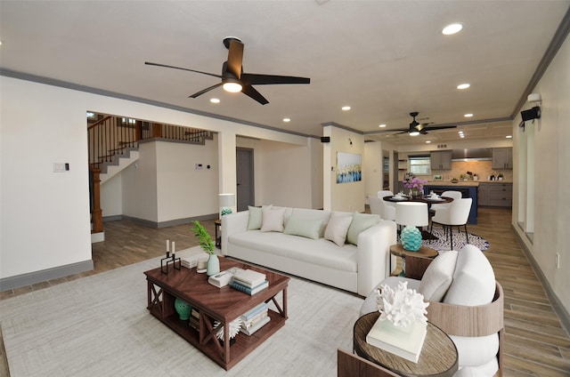 living room featuring recessed lighting, crown molding, stairway, and wood finished floors