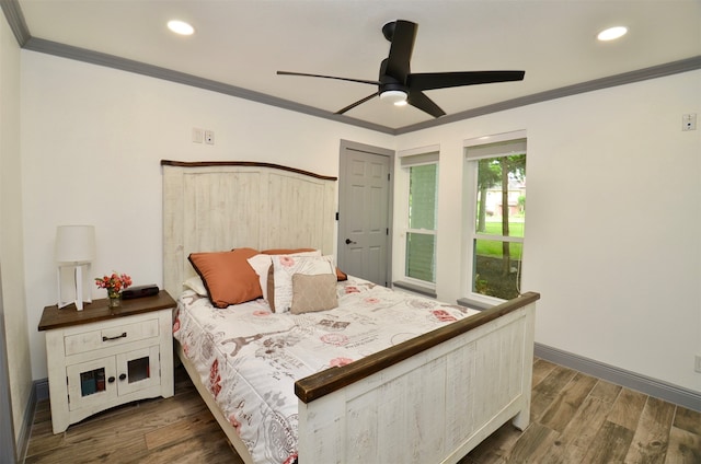 bedroom with baseboards, recessed lighting, wood finished floors, and crown molding