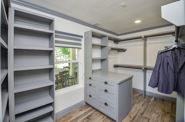 walk in closet with visible vents and wood finished floors