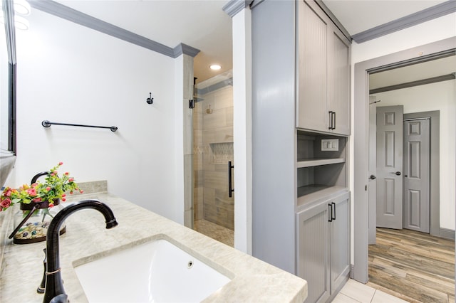 bathroom with a shower stall, ornamental molding, and vanity