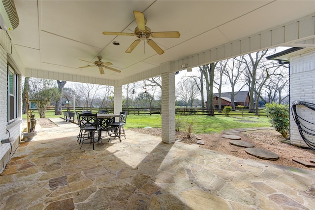 view of patio / terrace with fence, a ceiling fan, and outdoor dining space