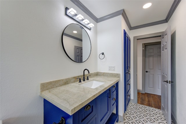 bathroom featuring recessed lighting, crown molding, vanity, and baseboards