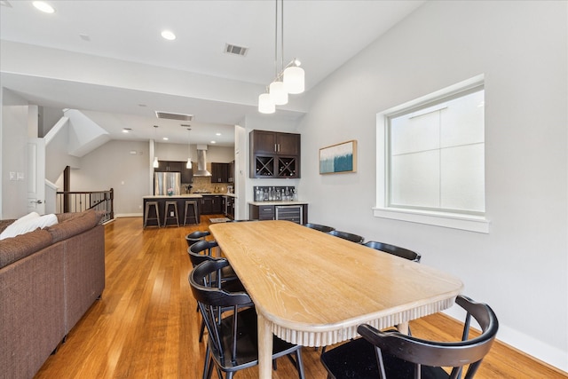 dining area with light wood-style floors, recessed lighting, and visible vents