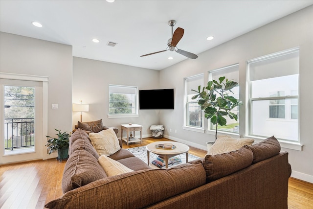 living room with visible vents, baseboards, ceiling fan, light wood-style floors, and recessed lighting