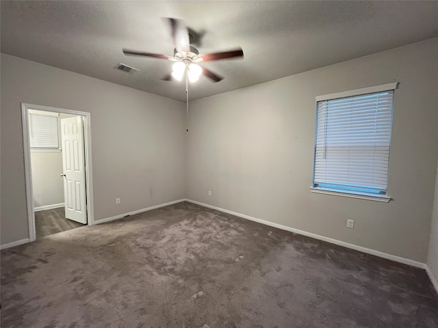 spare room with ceiling fan, baseboards, and carpet flooring