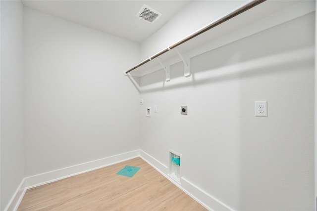 laundry room featuring light wood finished floors, hookup for a gas dryer, visible vents, hookup for an electric dryer, and laundry area