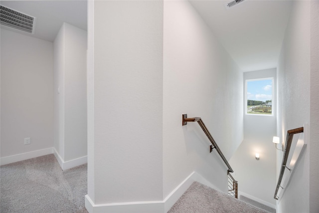 staircase featuring carpet, visible vents, and baseboards