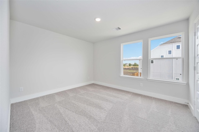 carpeted empty room with recessed lighting, visible vents, and baseboards