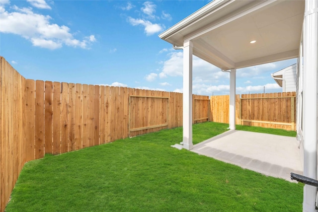 view of yard featuring a patio area and a fenced backyard