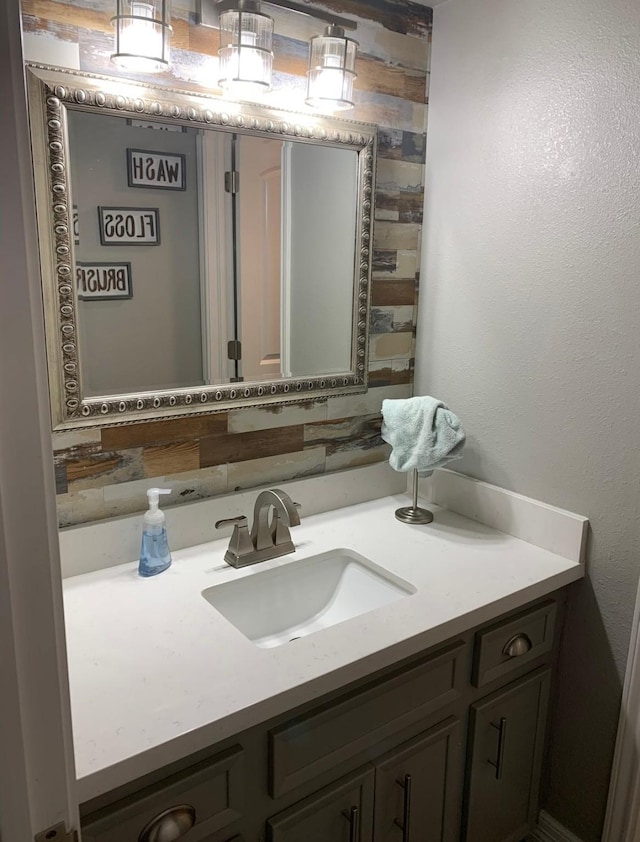 bathroom featuring vanity and decorative backsplash