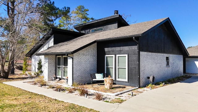 view of home's exterior with a garage and brick siding