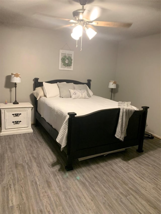 bedroom with ceiling fan and wood finished floors