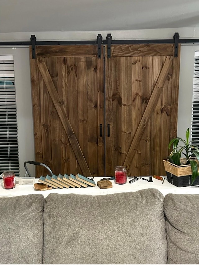 interior space with a gate and a barn door