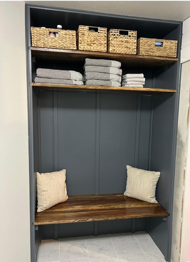 mudroom with marble finish floor