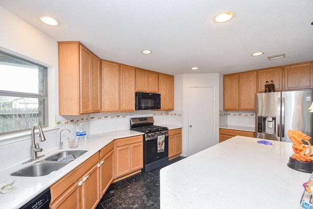 kitchen with decorative backsplash, light countertops, black appliances, a sink, and recessed lighting