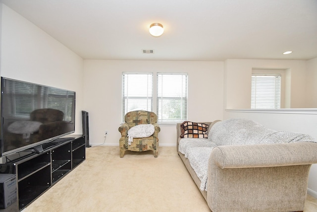 living area featuring carpet, visible vents, baseboards, and recessed lighting