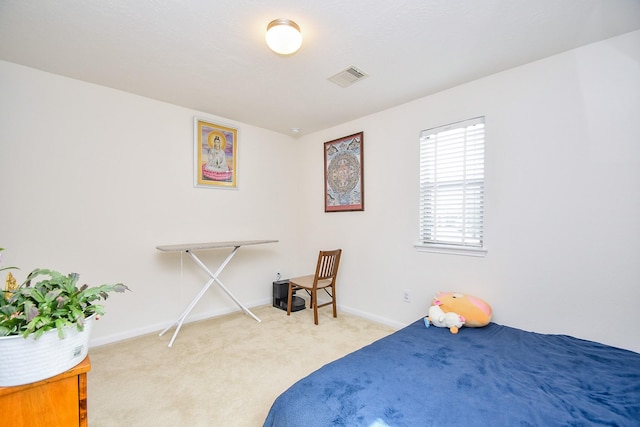 carpeted bedroom with baseboards and visible vents