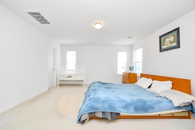 bedroom featuring carpet floors, multiple windows, and visible vents