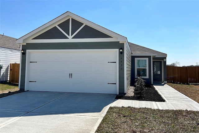 single story home featuring an attached garage, fence, and concrete driveway