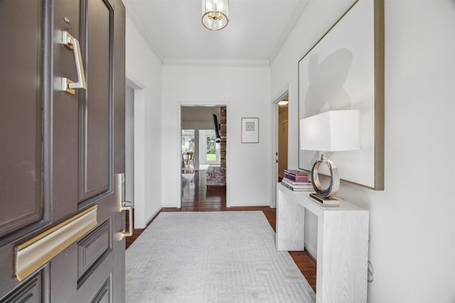 entryway with baseboards, ornamental molding, and dark wood-style flooring