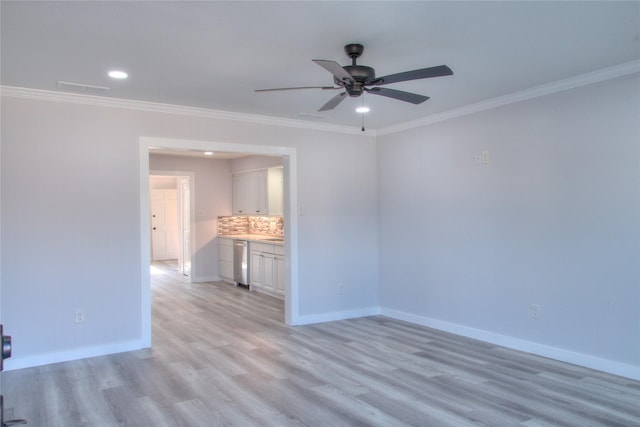 empty room featuring light wood finished floors, ceiling fan, baseboards, and ornamental molding