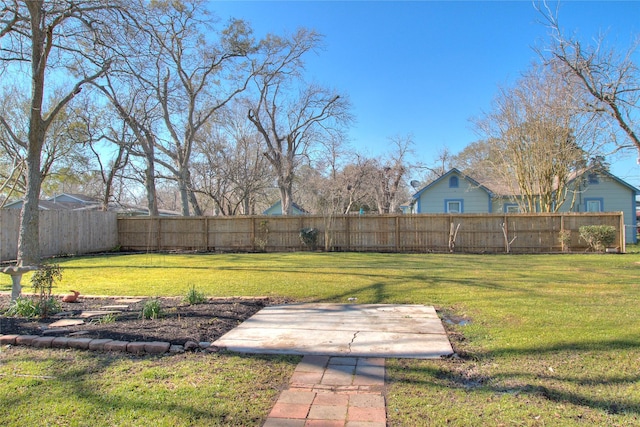 view of yard featuring fence and a patio