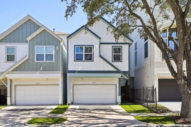 view of front facade featuring driveway, a garage, fence, and board and batten siding