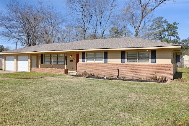 single story home with a front yard, brick siding, and an attached garage