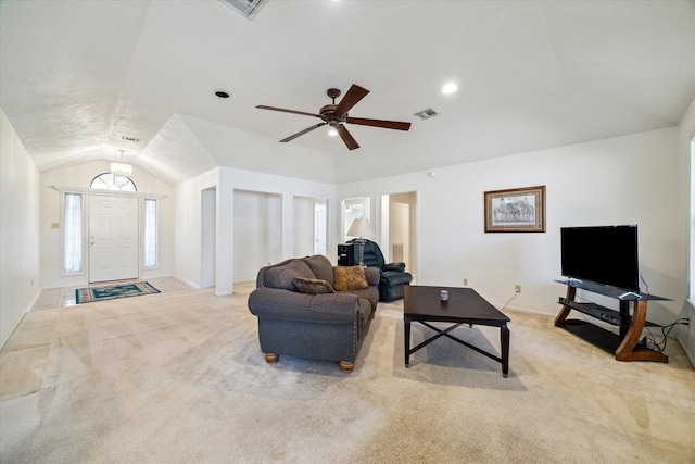 carpeted living room featuring baseboards, visible vents, vaulted ceiling, and a ceiling fan