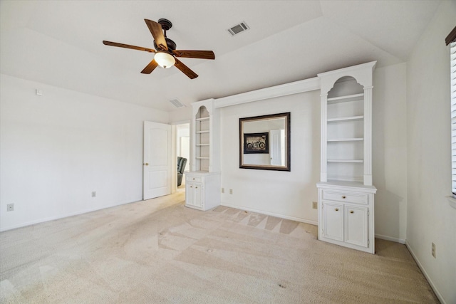 interior space with light colored carpet, lofted ceiling, visible vents, and a ceiling fan