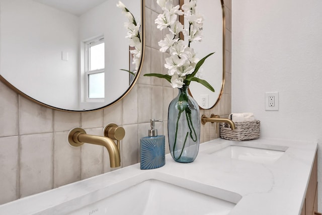 details with double vanity, a sink, and tasteful backsplash