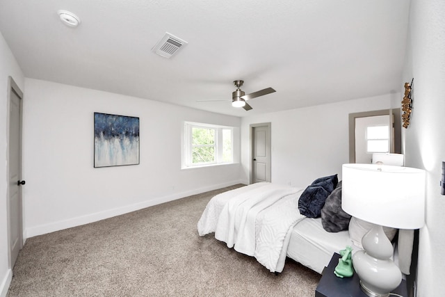 bedroom featuring visible vents, a ceiling fan, carpet, and baseboards