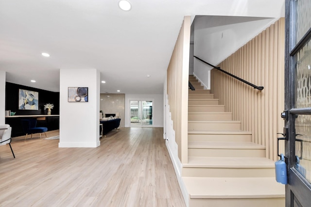 stairs with recessed lighting and wood finished floors