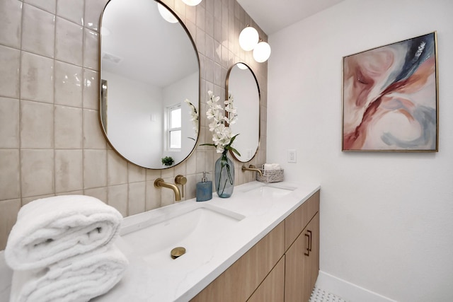 bathroom with a sink, tile walls, double vanity, and visible vents