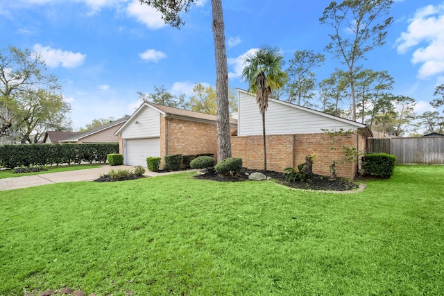 view of property exterior with driveway, fence, a yard, a garage, and brick siding