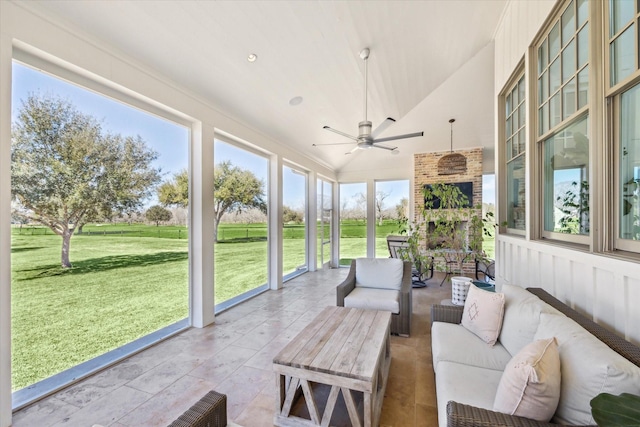 sunroom featuring vaulted ceiling and a ceiling fan