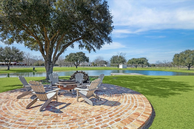 view of patio featuring a water view and a fire pit