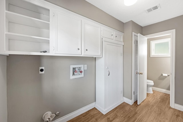 laundry room with light wood-type flooring, hookup for a washing machine, visible vents, and electric dryer hookup