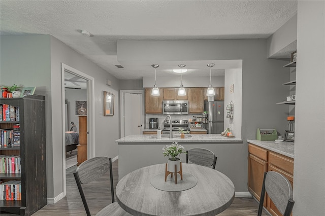 dining area featuring visible vents, a textured ceiling, baseboards, and dark wood-style flooring