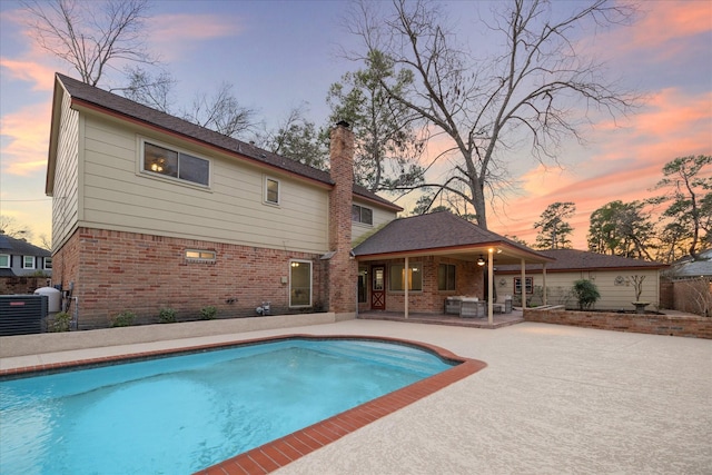 pool with a patio area and cooling unit