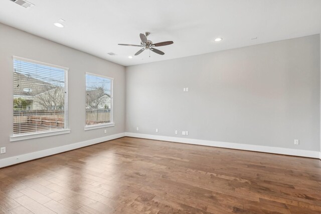 spare room with recessed lighting, visible vents, baseboards, and wood finished floors