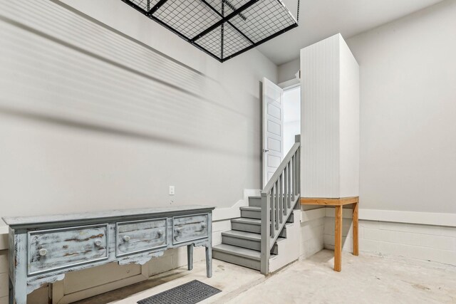 stairway featuring concrete floors