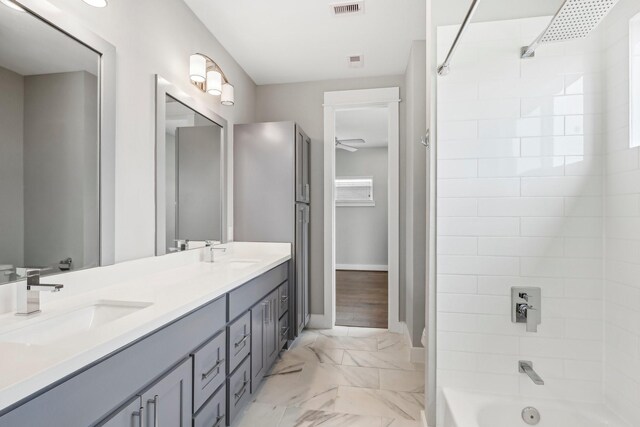 full bathroom with marble finish floor, a sink, shower / tub combination, and double vanity