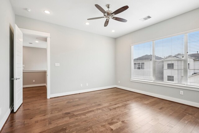 spare room with recessed lighting, wood finished floors, visible vents, and baseboards