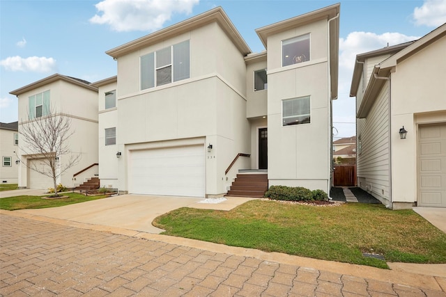 view of front of home featuring a garage, driveway, and stucco siding