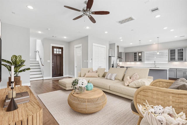 living room featuring wood finished floors, visible vents, and recessed lighting