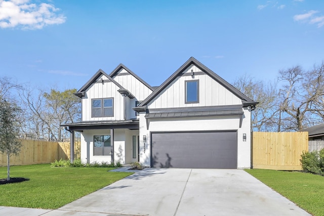 modern inspired farmhouse featuring fence, a front lawn, concrete driveway, a garage, and board and batten siding