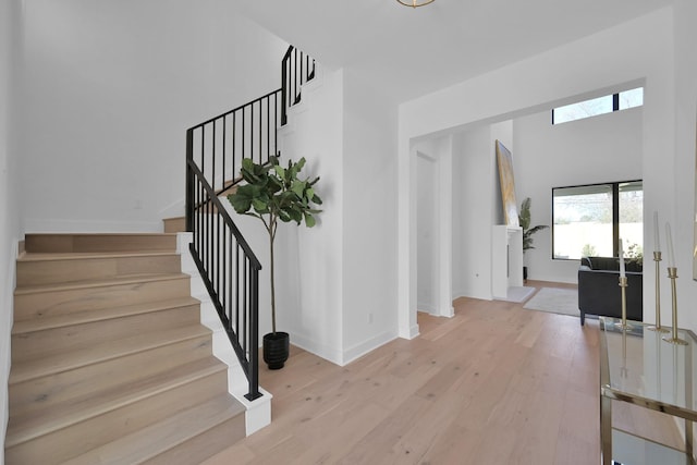 stairs featuring baseboards and wood finished floors