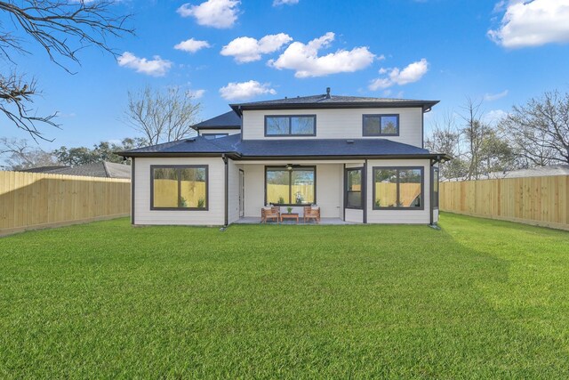 back of house with a patio, a yard, a fenced backyard, and ceiling fan