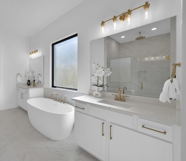 full bathroom with a marble finish shower, a freestanding bath, two vanities, marble finish floor, and a sink